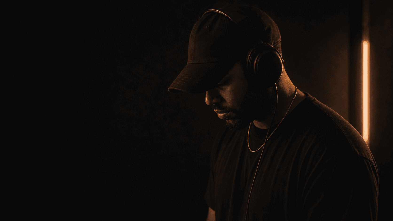 Music producer working quietly in a dark studio